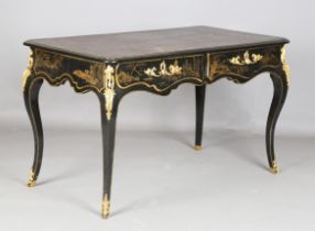 A late 19th/early 20th century black chinoiserie writing table, the serpentine top inset with tooled