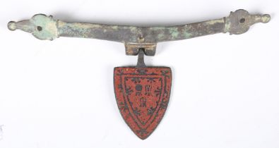 A 13th century red enamelled copper alloy shield shaped pendant, length 4.3cm, together with a