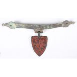 A 13th century red enamelled copper alloy shield shaped pendant, length 4.3cm, together with a