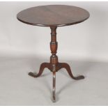A George III provincial mahogany and elm tip-top wine table, on a turned stem and tripod legs,
