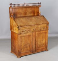 An 18th century and later walnut bureau with a gallery back above a fall flap, three drawers and two