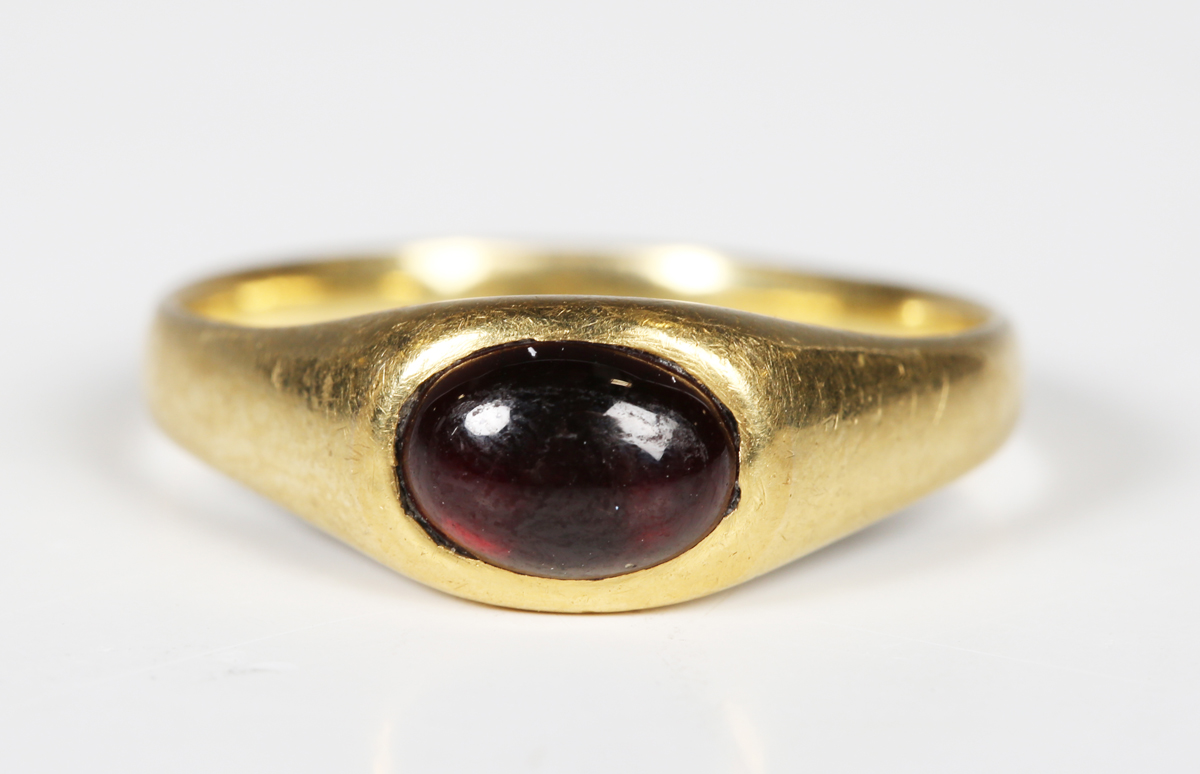 A medieval gold and garnet cabochon set ring, the garnet probably a later replacement, diameter 2cm. - Image 6 of 6