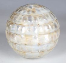 A late 20th century mother-of-pearl veneered sphere, diameter 14cm.Buyer’s Premium 29.4% (