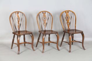A set of three early 20th century ash and elm Windsor chairs with cabriole front legs and
