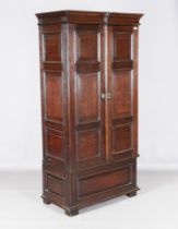 A 17th century and later oak panelled hall cupboard, fitted with two doors, height 192cm, width