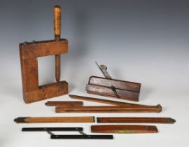 A small group of early 20th century hand tools, including three brass mounted folding rules and a