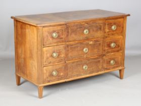 A late 18th century French walnut three-drawer commode, the breakfront top inlaid with flower