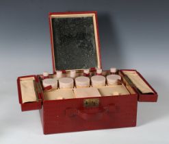 A mid-20th century red crocodile effect travelling vanity case by Elizabeth Arden, width 36cm.