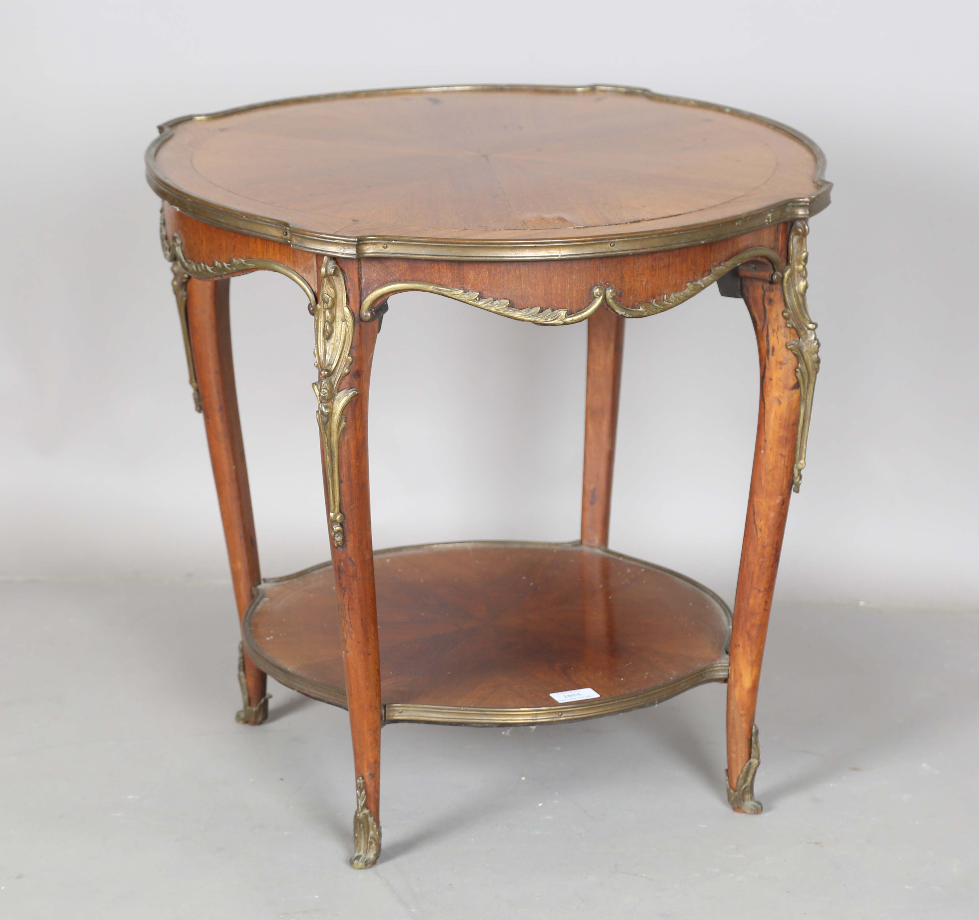 An early 20th century French walnut two-tier occasional table with radial veneers and gilt metal