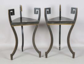 A pair of late 20th century French Empire style ebonized stands with gilt line decoration, raised on
