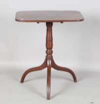 A Regency mahogany rectangular tip-top wine table, raised on a ring turned stem and tripod legs,