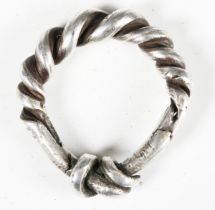 A Viking style silver finger ring of spiral knot form, length 3.2cm.Buyer’s Premium 29.4% (including