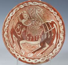 A Khorasan tin glazed earthenware bowl, probably 10th century AD, the deep sided interior