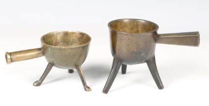 A small 17th/18th century patinated bronze skillet with rounded bowl and tripod feet, height 10.5cm,