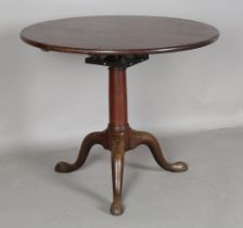 A George III mahogany circular tip-top supper table, the substantial stem with a birdcage mount