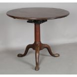 A George III mahogany circular tip-top supper table, the substantial stem with a birdcage mount