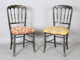 A pair of Victorian ebonized side chairs with gilded decoration and needlework seats, height 87cm,