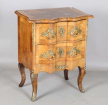 A small late 19th century French style walnut and gilt metal mounted two-drawer commode with a