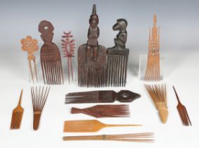 A collection of various hair combs, including four African hardwood examples and other ethnic