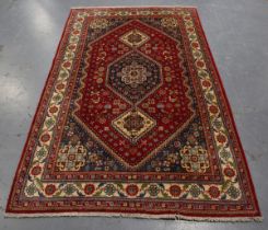 An Abadeh rug, South-west Persia, late 20th century, the red field with a stepped medallion