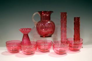 A mixed group of cranberry glassware, 19th and 20th century, including a set of ten circular