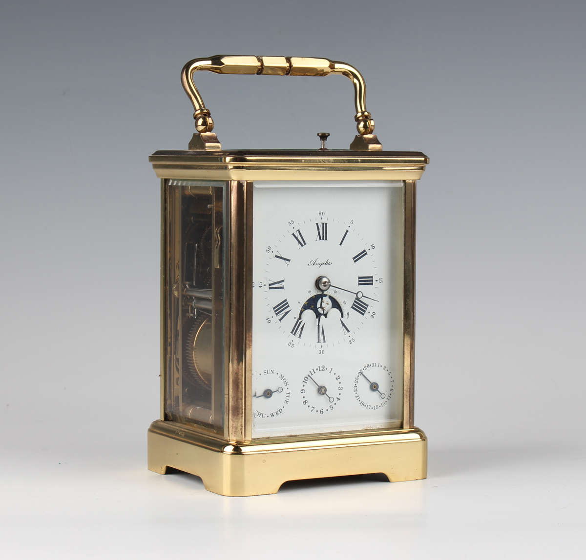 A late 20th century French lacquered brass corniche cased calendar carriage alarm clock by L'Epée,