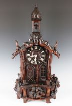 A rare late 19th century Black Forest automaton table clock in the form of a chapel, with two