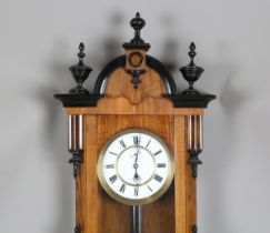 A late 19th century walnut and ebonized Vienna style wall timepiece with weight driven single