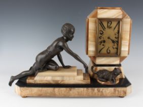 An Art Deco French brown onyx, slate and spelter mantel clock with eight day movement striking on