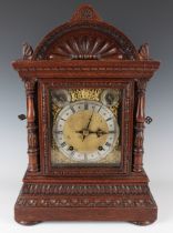 A late 19th century German oak cased mantel clock with two train eight day movement striking the