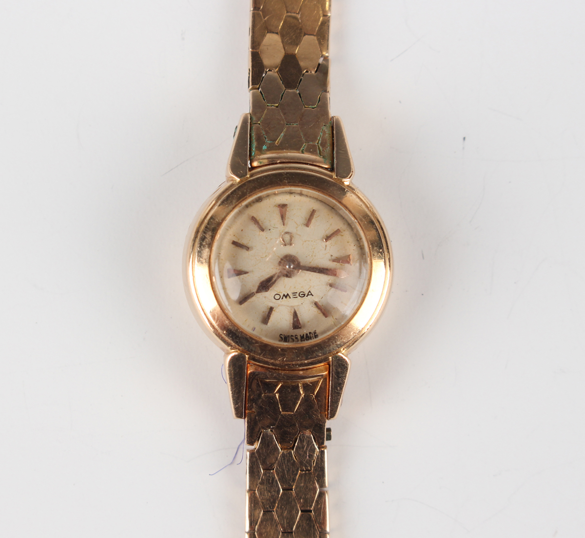 An Omega 18ct gold lady's rear-winding bracelet wristwatch, the signed silvered circular dial with