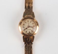 An Omega 18ct gold lady's rear-winding bracelet wristwatch, the signed silvered circular dial with