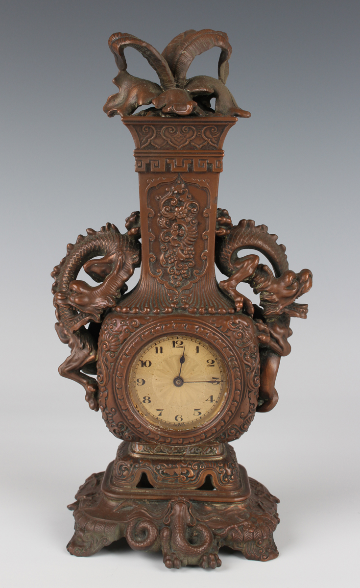 A late 19th century French chinoiserie bronze effect cast metal mantel timepiece, the gilt