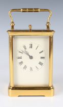 An early 20th century French lacquered brass carriage clock with eight day movement striking and