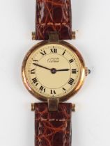 A Must de Cartier Quartz silver gilt circular cased lady's wristwatch, the signed dial with black