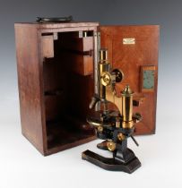 An early 20th century lacquered brass and black enamelled monocular microscope, signed 'E. Leitz