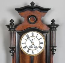 A late 19th century walnut and ebonized Vienna style wall timepiece with single train movement,