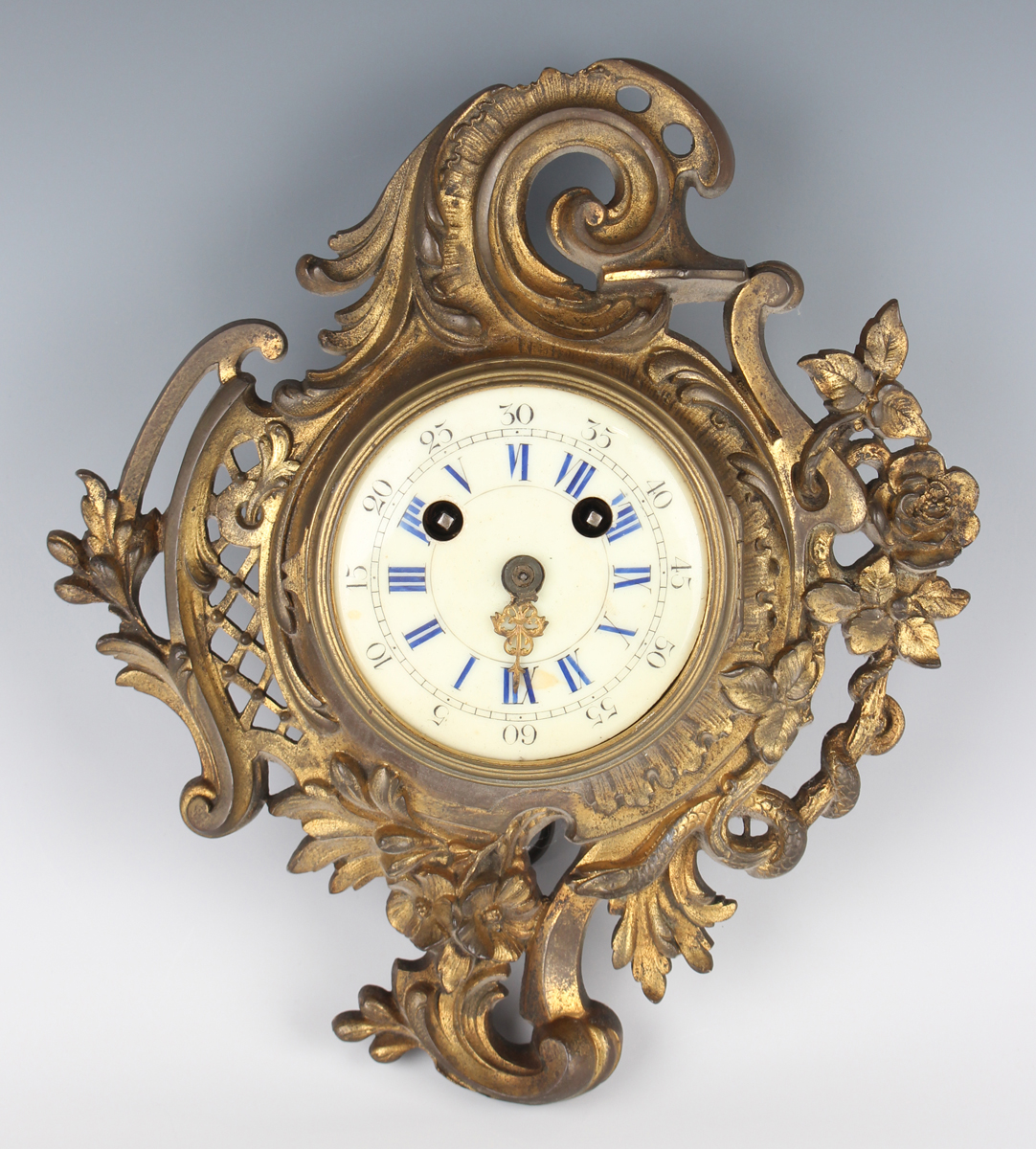 A late 19th century French gilt metal cased wall clock with eight day movement striking on a bell,