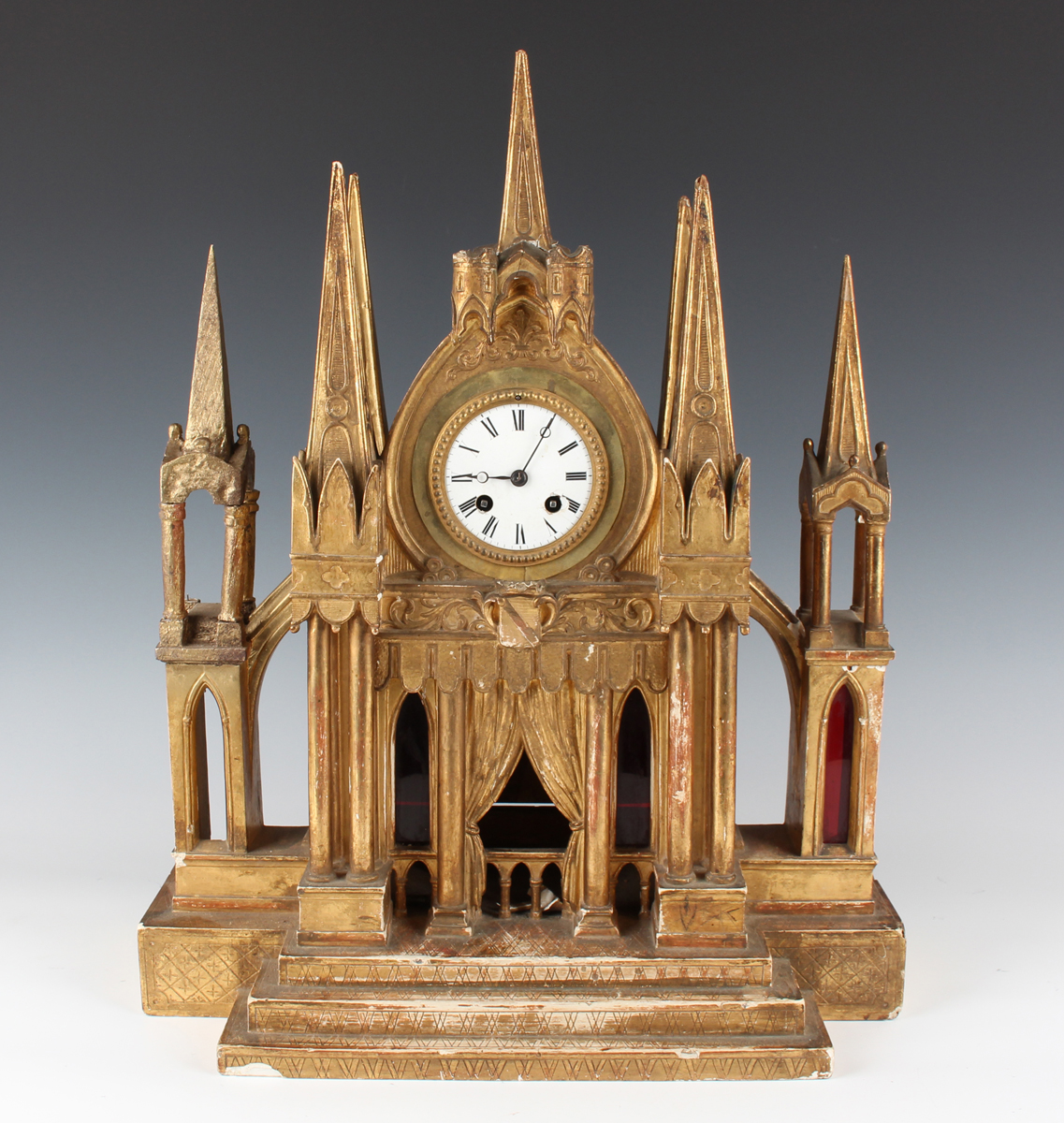 A late 19th century French Gothic Revival giltwood mantel clock with eight day movement striking