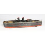 A German tinplate eccentric three-wheeled gunboat 'America', with two funnels and four guns,