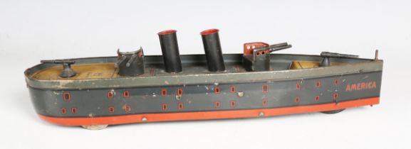 A German tinplate eccentric three-wheeled gunboat 'America', with two funnels and four guns,