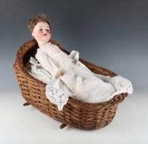An Armand Marseille bisque socket head doll, impressed '390n D.R.G.M 246/1 A4M', with brown wig,