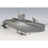 A Duco tinplate clockwork submarine, repainted in grey, with adjustable keel weight, length 38cm.