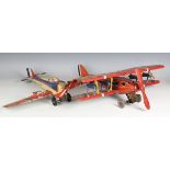 A British tinplate clockwork biplane airliner, possibly Chad Valley, finished in red with Dunlop