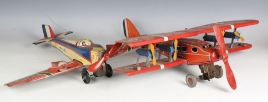 A British tinplate clockwork biplane airliner, possibly Chad Valley, finished in red with Dunlop