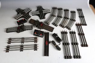 A collection of Lionel gauge O three-rail curves, short straight track, points, track plates and