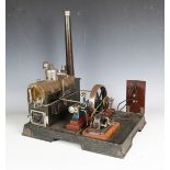 A Märklin live steam plant, the horizontal brass boiler with chimney powering a 12cm flywheel and