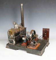 A Märklin live steam plant, the horizontal brass boiler with chimney powering a 12cm flywheel and