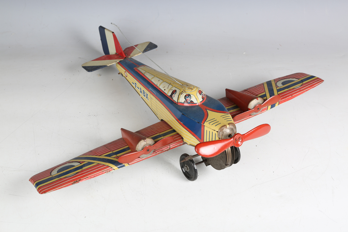 A British tinplate clockwork biplane airliner, possibly Chad Valley, finished in red with Dunlop - Image 3 of 5