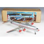 A Yonezawa tinplate battery operated Multi-Act DC-7C plane 'American Airlines' with moving